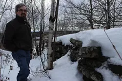 Archeologist Jeff Turner shows tours the mystery walls.