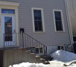 Image of a house with a for sale sign.
