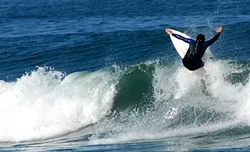 Local surfers worry that good will they've built up in the Cow Bay community will be wiped out by the O'Neill Cold Water Classic.