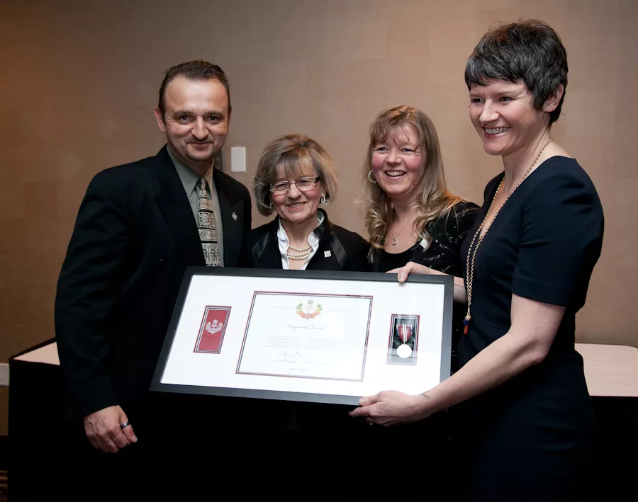 Megan Leslie presents Raymond Taavel's family with his Diamond Jubilee medal