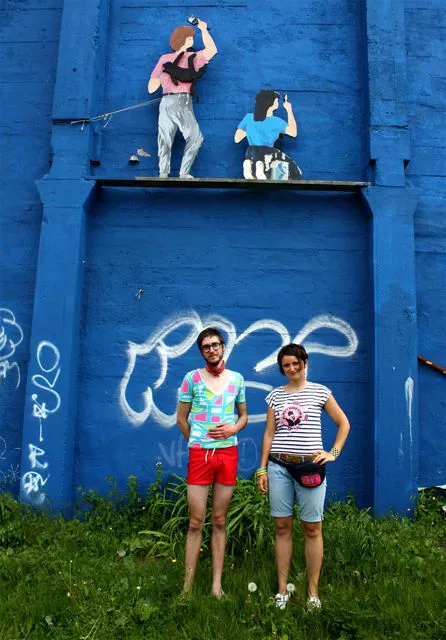 Mitchell, wearing an '80s-print tee and red drawstring shorts, gets his inspiration from Brent Halverson. If you spot him around town, he'll most likely be wearing a silk neck scarf like this one. Zsuzsa's accessories are her secret weapon; she's wearing an olive belt with Navajo-style embroidery, a fanny pack with a woven rainbow pocket, green and yellow bangles on one wrist and a beaded cuff on the other.