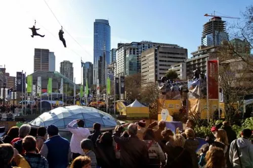 Olympics Day 3, Robson Square: 15 degrees Celsius.  Dozens salute the bravery of freestyle zip liners.