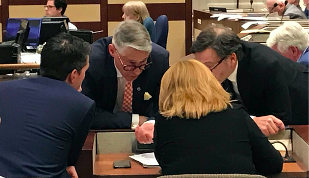 CAO Jacques Dubé (centre left) consults with planning staff and legal director John Traves in the middle of Tuesday's meeting. - THE COAST