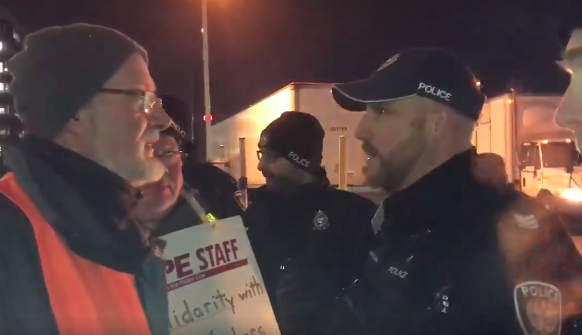 A screenshot from the video showing Ottawa police confronting activists picketing for Canada Post employees. - VIA FACEBOOK
