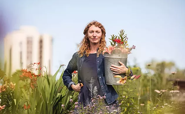 Jayme Melrose, Common Roots Urban Farm's business developer stands in the farm's soon-to-be former home. - RILEY SMITH