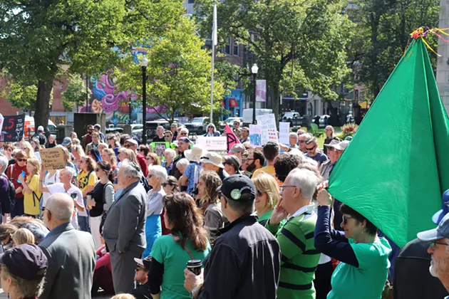 A Green Party supporter waves her flag as she takes part in the rally. - ISABEL BUCKMASTER