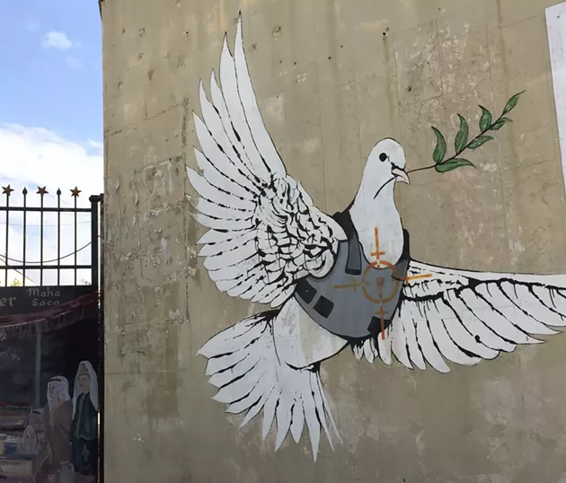 This photo was taken of a Banksy piece in Bethlehem on the separation apartheid wall that runs across the 1967 borders. - SUBMITTED