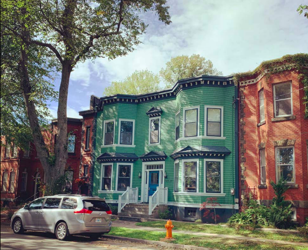 The first of six rowhouses constructed on this Halifax street, 6047 Jubilee Road originally a detached wooden one-and-a-half storey homestead with a gable roof. - HRM