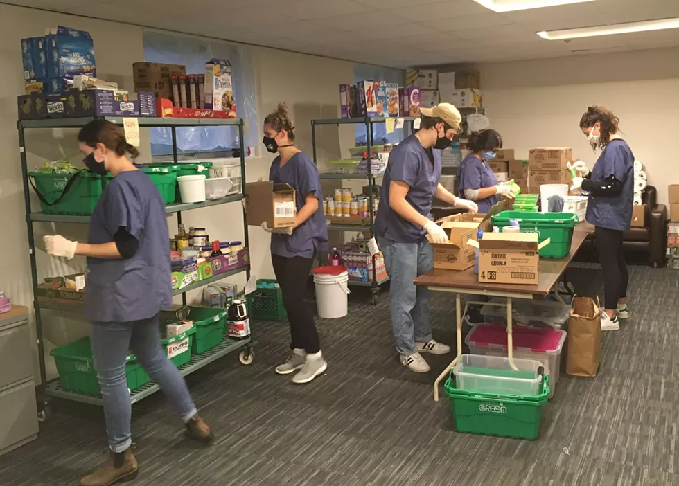 At the DSU food bank, volunteers prepare boxes for pick-up. - THE COAST