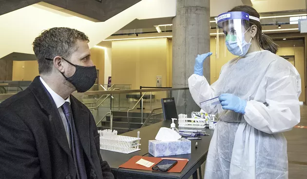 Before he could attend his swearing-in ceremony to become premier of Nova Scotia, Iain Rankin was just another person deciding which nostril to offer for a rapid COVID-19 test. - Dal health student Harriet Wright was at the convention centre this morning to do the swabbing honours. - COMMUNICATIONS NOVA SCOTIA