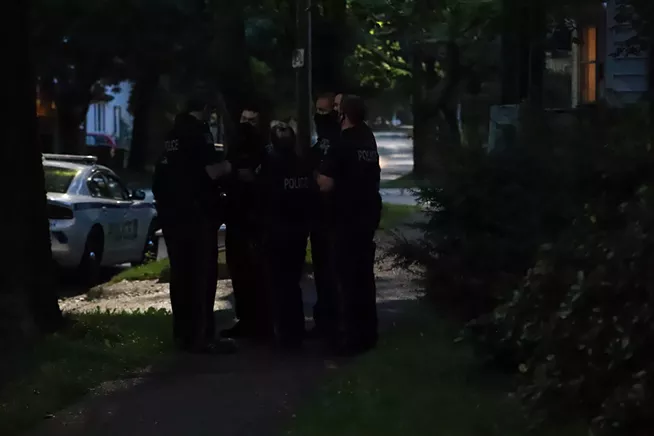 HRP officers huddle together on the sidewalk near Meagher Park while waiting for instructions. - VICTORIA WALTON/THE COAST