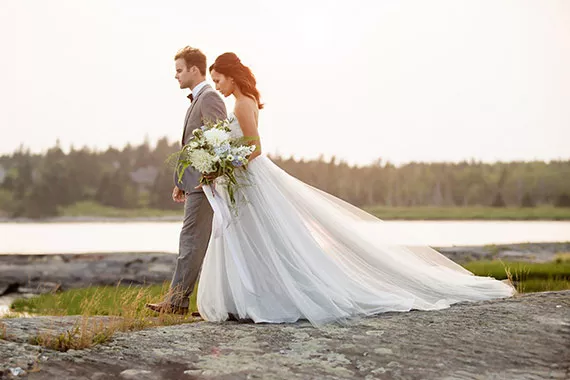 The Addilyn: Inspired by the coastline, this gown uses colours and textures that reflect it—layers of ivory and grey tulle, over a base of duping silk and hand-sewn appliqués. - CHANTAL ROUTHIER PHOTOGRAPHY