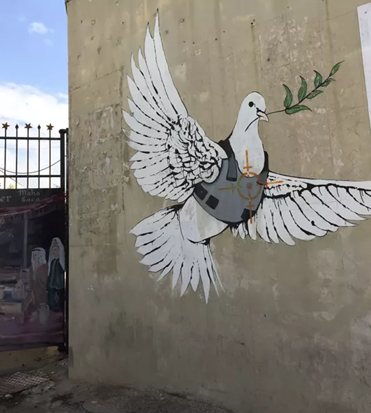 This photo was taken of a Banksy piece in Bethlehem on the separation apartheid wall that runs across the 1967 borders. - SUBMITTED