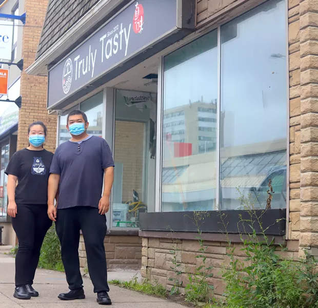 Shanshan Liu and Jian Li stand outside their new, bigger Truly Tasty, which is set to open Oct 23. - VICTORIA WALTON