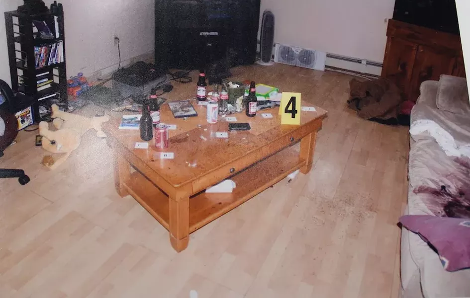 This photo exhibit from the trial shows the murder scene at John Lively's house, with bloody couch at right.