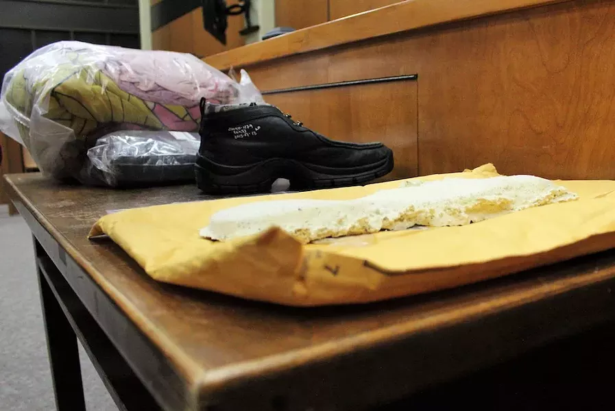 Police introduced a size 12 shoe as evidence, along with the casting (foreground) of a footprint from the murder scene. Jimmy Melvin Jr. wears size 12; Derek MacPhee is 10.5 or 11.