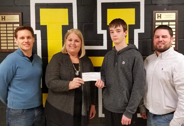 Natural Resources minister Margaret Miller hands a cash prize to one of the mining video contest winners. - VIA FACEBOOK