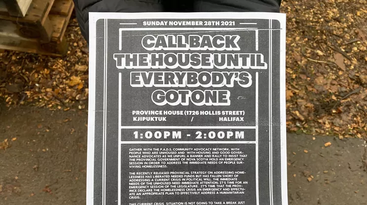 A P.A.D.S. volunteer holds a poster for the Sunday event.