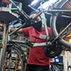 Robin Young and Raoul Tanyan fix up a bike. Robin Young and Raoul Tanyan fix up a bike.