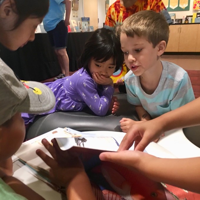 UofA Fusion campers from the kindergarten/first grade group read through David Wiesner’s “Flotsam,” which takes readers on a surreal journey through an underwater world. Flotsam is one of dozens of books on display at Worlds of Words as part of their Visual Narratives exhibit.