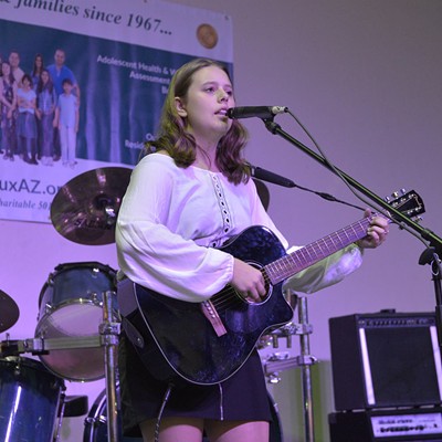 Girl playing guitar at 2018 KidsROCK event, benefiting Devereux Arizona's foster care youth