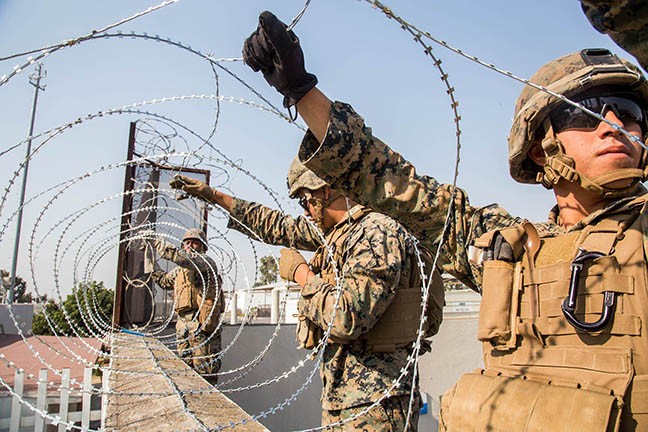 U.S. Marines with the 7th Engineer Support Battalion place concertina wire at the Otay Mesa Port of Entry in California on Nov. 11, as part of the deployment of thousands of active-duty troops to support border security efforts.