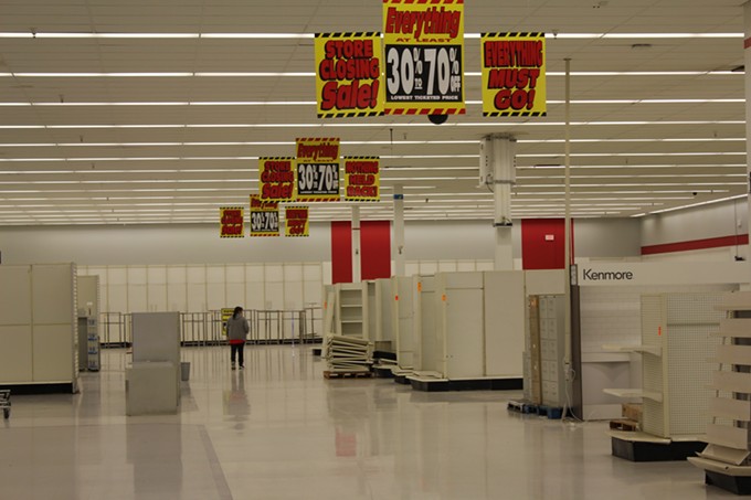 An employee walks through the empty aisles of Tucson’s last Kmart.