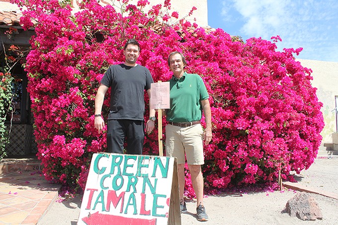 Mike Holquist, Jr., and father Mike Sr., hold the City of Tucson sign informing Lerua’s Restaurant that their property has “been appraised and an offer made.”