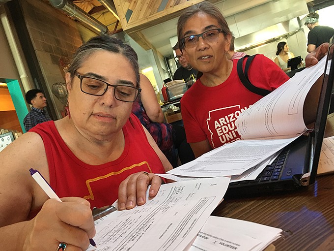 Tucson High teacher Marea Jenness signs the INVESTinED ballot initiative.