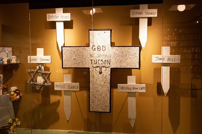 Six white crosses commemorate those who died in the shooting of Jan. 8, 2011.
