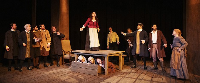 Bryn Booth as Abigail Williams and the cast of The Crucible.