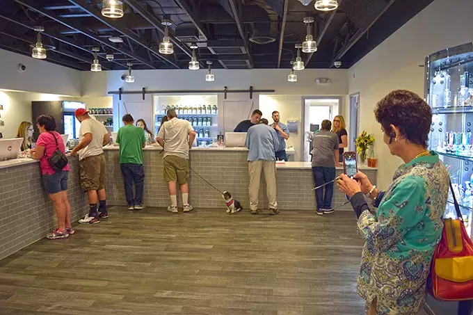 Owner Vicky Puchi-Saavedra surveys the floor of the new Earth’s Healing location on opening day. - NICK MEYERS
