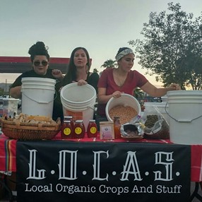 Women in the Food Justice Organization, L.O.C.A.S, hand out food samples. - L.O.C.A.S - LOCAL ORGANIC CROPS AND STUFF