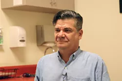 “The kids we see will usually have been talking to their parents about gender at home for six months to a year before they even consider talking to a doctor about it,” says Dr. Andrew Cronyn of El Rio Health in Tucson, photographed Feb. 26, 2020. (Photo by Annabella Piunti/Cronkite News)