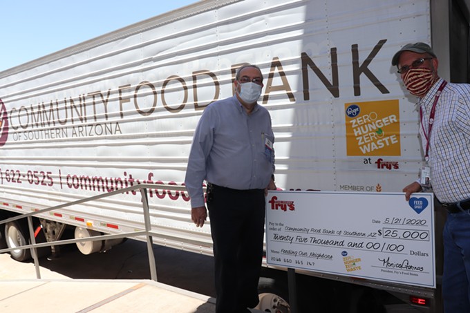 Mel Ryan, Fry’s Food Stores Tucson District Manager (left) and Michael McDonald, CEO of the Community Food Bank of Southern Arizona (right) holding the $25,000 check.