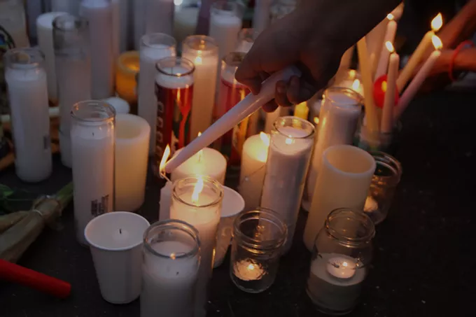 Participants light candles after the moment of silence for George Floyd at the Dunbar Pavilion on Monday, June 1. "Remember the faces who talked today. Remember your brother to your left and your right today," Event organizer Jahmar Anthony said at vigil's commencement. "Look who's next to you. All races. We're fighting the same fight. Enough is enough." - AUSTIN COUNTS