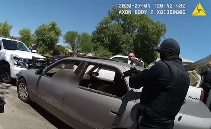Body camera footage shows Phoenix Police officers converging on a car after shooting a man who they said was wielding a handgun and who refused to put it down during a July 4 incident. Advocates are demanding to see more of the video footage. (Image courtesy Phoenix Police Department)