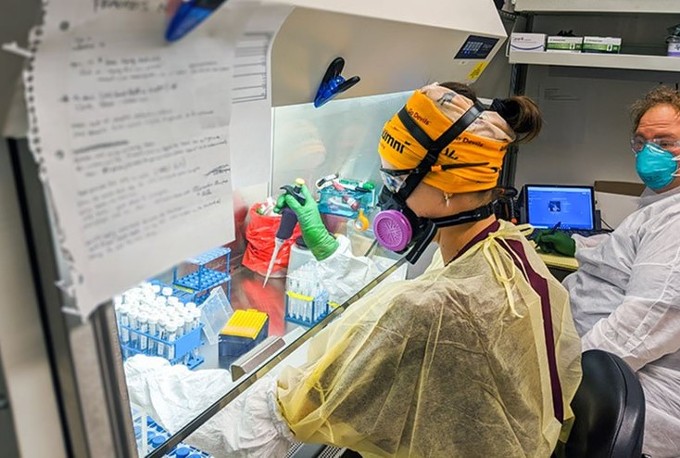 Researchers at the ASU Biodesign Institute must wear protective gear when working with COVID-19 test samples. (Photo courtesy of the ASU Biodesign Institute)