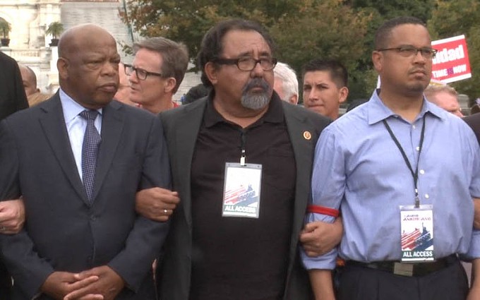 Democratic Reps. John Lewis of Georgia, Raul Grijalva of Tucson and Keith Ellison of Minnesota link arms prior to being arrested outside the Capitol in 2013 as part of a rally in support of comprehensive immigration reform. Grijalva said Lewis, arrested scores of times in civil rights protests, later jokingly asked him, “First time, kid?” (File photo by Nela Lichtscheidl/Cronkite News)