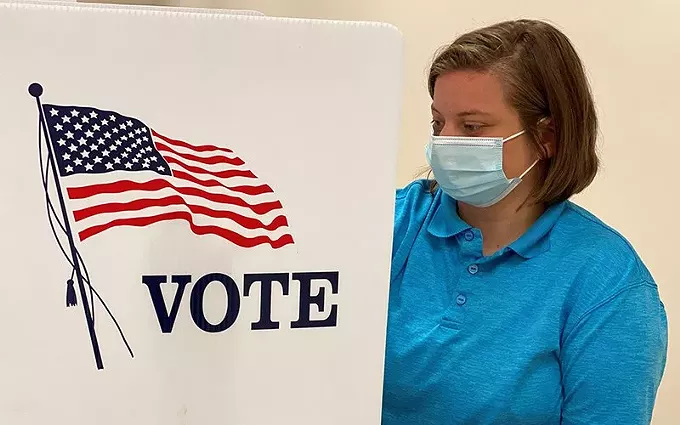 Health care is an issue in the 2020 election, but COVID-19 is not the main health care concern for voters in Arizona and other battleground states, according to a new poll. It ranked coverage for people with pre-existing conditions high. Here, a Kentucky National Guard ROTC cadet sanitizes a voting station in this June photo. - PHOTO BY CAPT. CASSANDRA MULLINS, NATIONAL GUARD, CREATIVE COMMONS