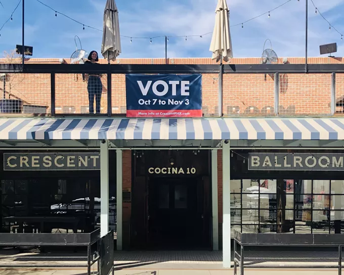 Crescent Ballroom General Manager Angela Donato stands by a "vote" banner at the downtown Phoenix music venue. - MARIA LEKMAN