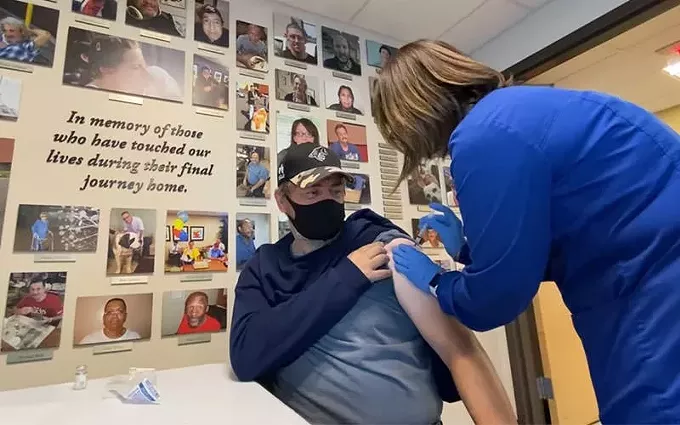 Medical staff at Circle the City, a nonprofit that provide health care to those experiencing homelessness in Maricopa County, gives a man his first dose of the COVID-19 vaccine on Jan. 29, 2021, in Phoenix. - CIRCLE THE CITY