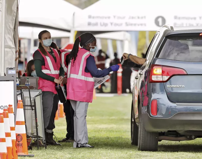 Volunteers assist drivers at COVID-19 vaccine point of distribution at the University of Arizona’s Campus Mall. - THE UNIVERSITY OF ARIZONA