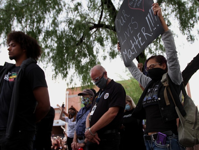 Tucson Police Chief Chris Magnus bows his head during a moment of silence during a vigil for George Floyd. - FILE PHOTO BY AUSTIN COUNTS