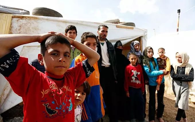 A family in a Lebanese refugee camp in a 2013 file photo. After years of cuts under the Trump administration, President Joe Biden said this month that he wants to raise the cap on refugee admissions, but few – including Biden – expect to come near the limit this year. - DRAGAN TATIC, AUSTRIAN MINISTRY OF FOREIGN AFFAIRS/CREATIVE COMMONS VIA CRONKITE NEWS