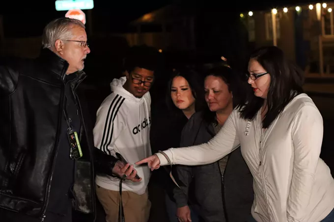 Xenia Kiever points out a possible ghost in a photo the Tombstone community provided to tour guide Larry Widen. - BLAKE BLASDELL, CRONKITE NEWS