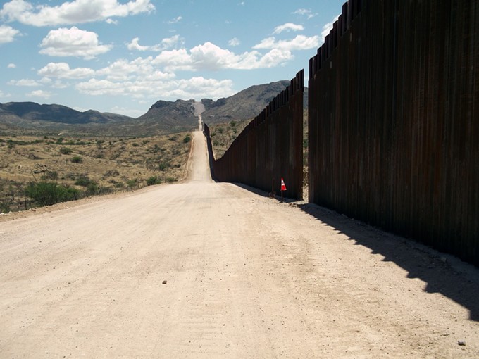 Looking east along a stretch of Trump’s 32-foot border wall near Sasabe. - LEO W. BANKS