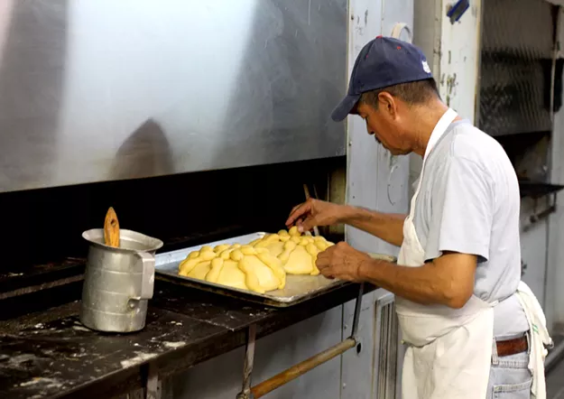 Adding a circular piece of dough as the wrist bone is the final touch before the bread goes into the oven. - HEATHER HOCH
