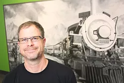 Brian Warde in front of Joe Pagac’s painting of the Tucson 420 train at the new Prime Leaf - HECTOR ACUNA