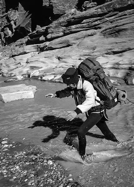 Charles Bowden fording Paria River in winter, 1986
